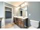 Bathroom featuring double vanity sinks with modern faucets, a large mirror, and a toilet at 609 Kahana River Rd, Fort Mill, SC 29715