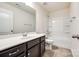 Bathroom with a dark vanity, large mirror, bathtub, and toilet at 609 Kahana River Rd, Fort Mill, SC 29715