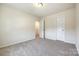 Carpeted bedroom showing the ensuite bathroom, closet and neutral wall color at 609 Kahana River Rd, Fort Mill, SC 29715