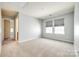 Spacious bedroom with neutral carpet, two windows and ensuite bathroom access at 609 Kahana River Rd, Fort Mill, SC 29715