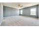 Spacious bedroom with neutral carpet, two windows and a ceiling fan at 609 Kahana River Rd, Fort Mill, SC 29715