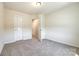 Carpeted bedroom showing the ensuite bathroom, closet and neutral wall color at 609 Kahana River Rd, Fort Mill, SC 29715