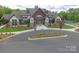 Exterior of clubhouse featuring large windows, stone and wood facade, and landscaping at 609 Kahana River Rd, Fort Mill, SC 29715