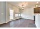 Dining area with hardwood floors, pendant lighting, and a door to the backyard, creating a bright and inviting atmosphere at 609 Kahana River Rd, Fort Mill, SC 29715