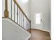 Foyer featuring a staircase with wrought iron spindles and a hardwood floor, creating a grand entrance to the home at 609 Kahana River Rd, Fort Mill, SC 29715