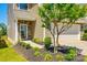 Well-manicured front yard with a tree and walkway leading to the front door, showcasing the home's inviting exterior at 609 Kahana River Rd, Fort Mill, SC 29715