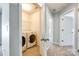 Bright laundry room featuring a washer, dryer and shelving at 609 Kahana River Rd, Fort Mill, SC 29715