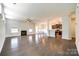 Open-concept living room with a fireplace, hardwood floors, and ample natural light, perfect for entertaining and relaxation at 609 Kahana River Rd, Fort Mill, SC 29715