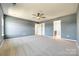 Expansive main bedroom featuring a ceiling fan, neutral gray walls, and plush carpeting for a modern and comfortable feel at 609 Kahana River Rd, Fort Mill, SC 29715