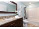 Light-filled bathroom with a single sink, vanity, and shower at 8013 Sheckler Ln, Matthews, NC 28104