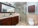 This bathroom has a beautiful granite countertop, a vessel sink, and a sleek glass walk-in shower at 8013 Sheckler Ln, Matthews, NC 28104