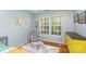 Comfortable bedroom features a glider and a window at 8013 Sheckler Ln, Matthews, NC 28104