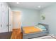 This bedroom has a hardwood floor and a neutral color scheme at 8013 Sheckler Ln, Matthews, NC 28104
