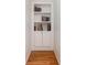 Built-in bookshelves with cabinet storage on the bottom and a hardwood floor at 8013 Sheckler Ln, Matthews, NC 28104