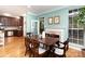 Open dining area with access to the kitchen and a view of the fireplace at 8013 Sheckler Ln, Matthews, NC 28104