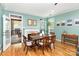 View of the dining room and backyard deck with plenty of natural light at 8013 Sheckler Ln, Matthews, NC 28104