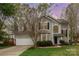 Attractive home featuring a well-manicured lawn, two-car garage, and elegant architectural details at 8013 Sheckler Ln, Matthews, NC 28104