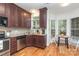 Eat-in kitchen featuring stainless steel appliances and warm wood cabinetry at 8013 Sheckler Ln, Matthews, NC 28104