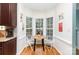 Bright breakfast nook with a round wood table, two chairs, and large windows overlooking the yard at 8013 Sheckler Ln, Matthews, NC 28104
