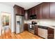 Updated kitchen with stainless steel appliances and beautiful dark wood cabinetry, and a stainless steel refrigerator at 8013 Sheckler Ln, Matthews, NC 28104