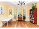 Bright and airy living room with hardwood floors, large windows, and decorative crown molding at 8013 Sheckler Ln, Matthews, NC 28104