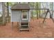Charming backyard playhouse with swing set, perfect for entertainment at 8013 Sheckler Ln, Matthews, NC 28104
