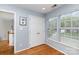 Brightly lit room with light blue walls, wood floor, windows with blinds, and a closet at 8013 Sheckler Ln, Matthews, NC 28104