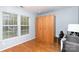 Bright room features hardwood floors, two large windows, and built in storage cabinet at 8013 Sheckler Ln, Matthews, NC 28104