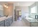 A modern bathroom with a marble vanity, soaking tub, and glass-enclosed shower at Tbd Boomer Ct # 10, Statesville, NC 28677