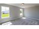 Cozy bedroom with neutral paint, soft carpet, and natural light from two windows at Tbd Boomer Ct # 10, Statesville, NC 28677