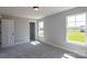 Bright bedroom features soft, neutral colors, plush carpet, two windows, and closet at Tbd Boomer Ct # 10, Statesville, NC 28677