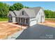 New construction featuring gray stone accents, attached two-car garage, and manicured landscaping at Tbd Boomer Ct # 10, Statesville, NC 28677