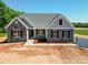 Charming single-story home with stone accents, gray siding, and a well-manicured yard at Tbd Boomer Ct # 10, Statesville, NC 28677