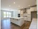 The spacious kitchen offers white cabinets, marble countertops, and stainless steel appliances at Tbd Boomer Ct # 10, Statesville, NC 28677