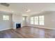 A cozy living room with a fireplace, large windows, and hardwood flooring at Tbd Boomer Ct # 10, Statesville, NC 28677