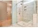 This bathroom features a tiled walk-in shower with glass door and marble-look tile at Tbd Boomer Ct # 11, Statesville, NC 28677