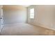 A bright bedroom with neutral carpet features one window at Tbd Boomer Ct # 11, Statesville, NC 28677