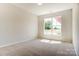 A bright bedroom with neutral carpet and walls features a large window at Tbd Boomer Ct # 11, Statesville, NC 28677