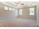 Large bedroom with trey ceilings, a ceiling fan, three windows, and neutral carpeting at Tbd Boomer Ct # 11, Statesville, NC 28677