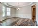 Formal dining room featuring a modern chandelier, wainscoting, and tray ceiling detail at Tbd Boomer Ct # 11, Statesville, NC 28677