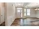 Bright foyer featuring a glass-paneled door, tray ceiling, and wood flooring at Tbd Boomer Ct # 11, Statesville, NC 28677