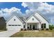 Charming new construction home with a manicured lawn and bright, white siding under a cloudy sky at Tbd Boomer Ct # 11, Statesville, NC 28677