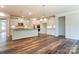 Open-concept kitchen featuring white cabinets, granite countertops, stainless steel appliances, and hardwood floors at Tbd Boomer Ct # 11, Statesville, NC 28677