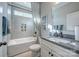 Bright bathroom with tiled tub, shower, and vanity with modern fixtures at Tbd Boomer Ct # 12, Statesville, NC 28677