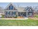 Charming single-story home with stone facade, blue shutters, covered porch, and well-manicured lawn at Tbd Boomer Ct # 12, Statesville, NC 28677
