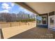 Spacious wooden back deck with a railing and a view of the surrounding trees and blue sky at Tbd Boomer Ct # 13, Statesville, NC 28677
