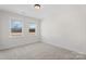 Bright, carpeted bedroom with neutral walls, features two windows and ample space at Tbd Boomer Ct # 13, Statesville, NC 28677