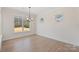 Well-lit dining room showcasing large windows and modern light fixture at Tbd Boomer Ct # 13, Statesville, NC 28677