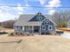 Charming home featuring a covered porch, stone accents, and eye-catching blue siding at Tbd Boomer Ct # 13, Statesville, NC 28677