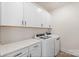 Functional laundry room with white cabinets, a quartz countertop, and modern washer and dryer at Tbd Boomer Ct # 13, Statesville, NC 28677